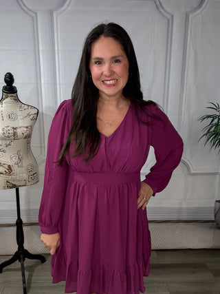 Woman wearing a berry long-sleeve tiered dress